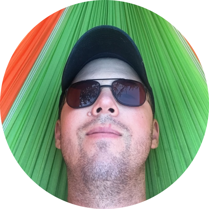 The website owner with sunglasses on relaxing in a hammock.